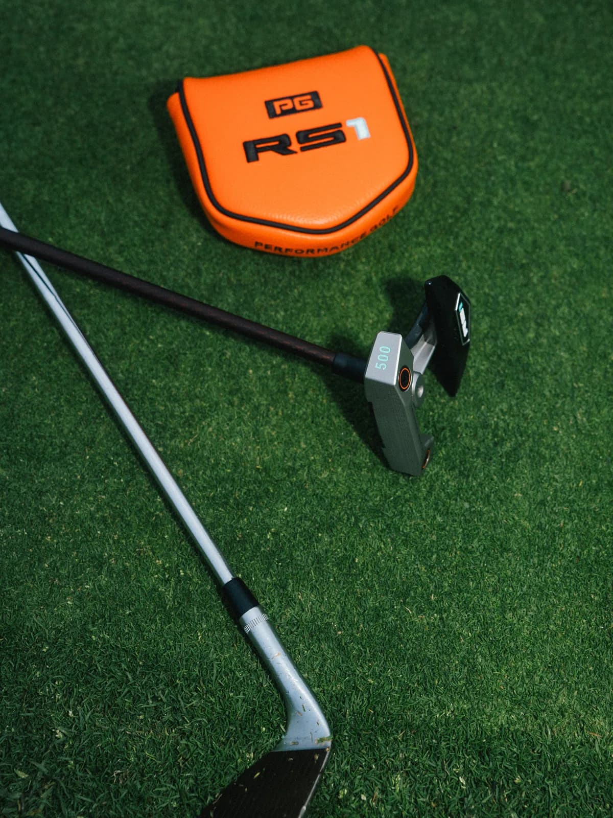 RS1 Founder's Edition putter with orange headcover on grass