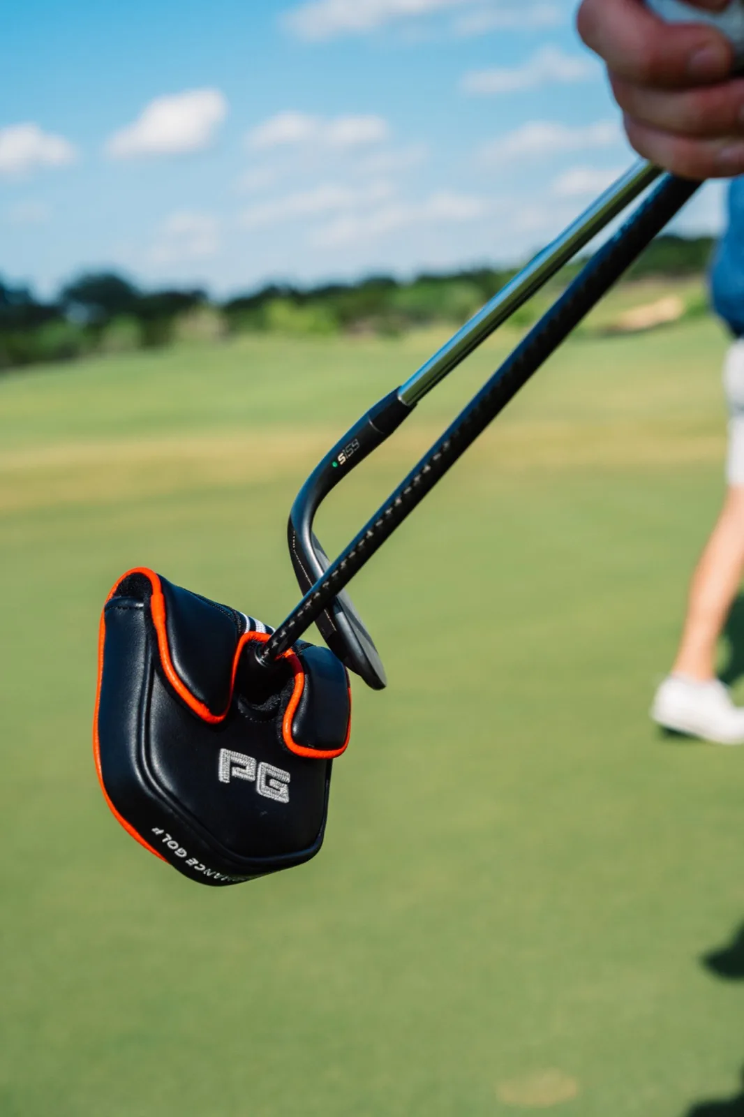 Performance Golf headcover hanging from golf bag on course