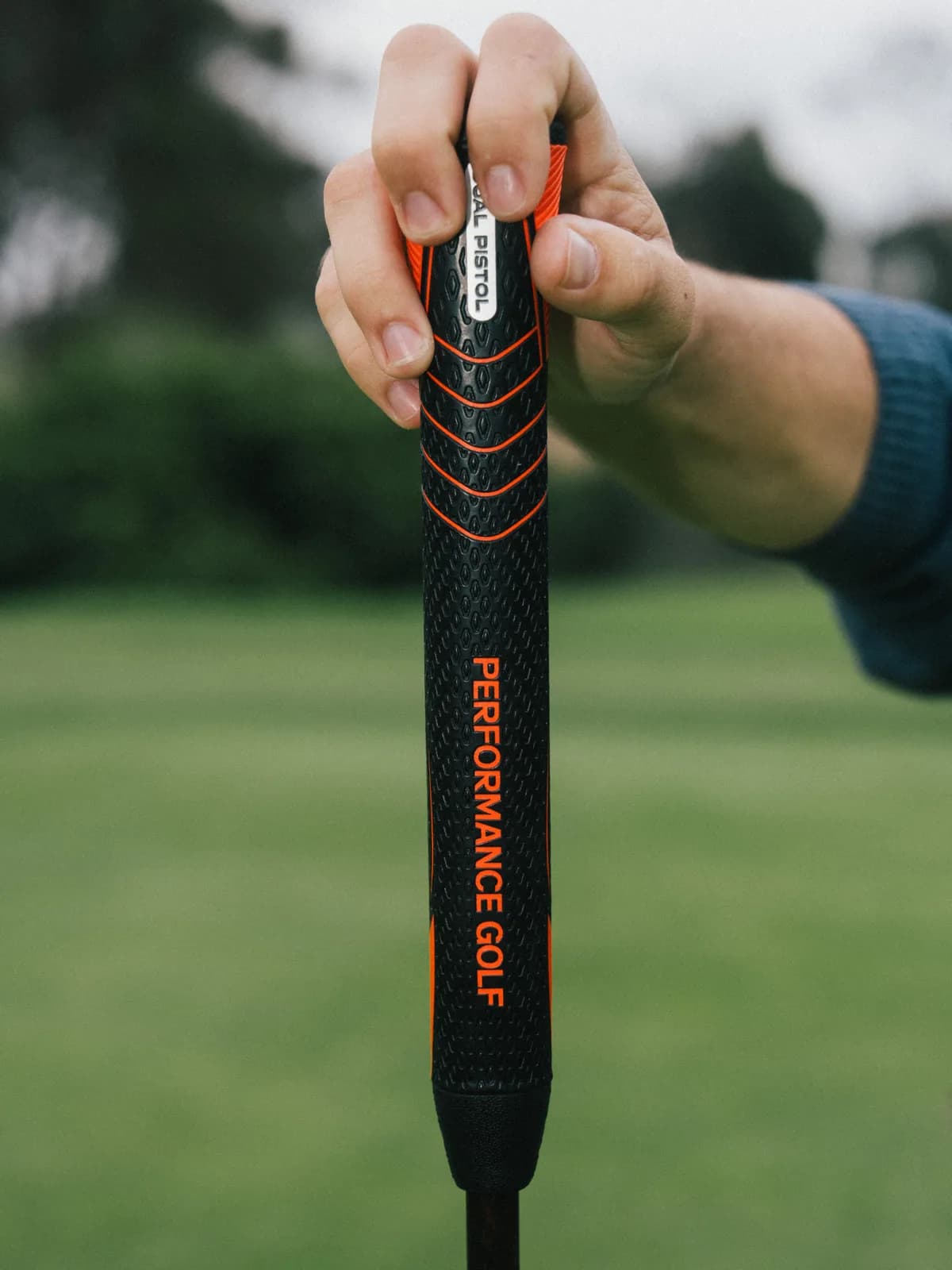 Dual Pistol grip in hand showing Performance Golf branding