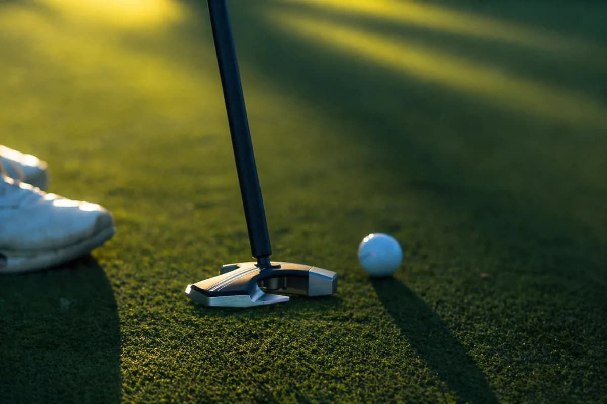 RS1 putter at address in golden hour light