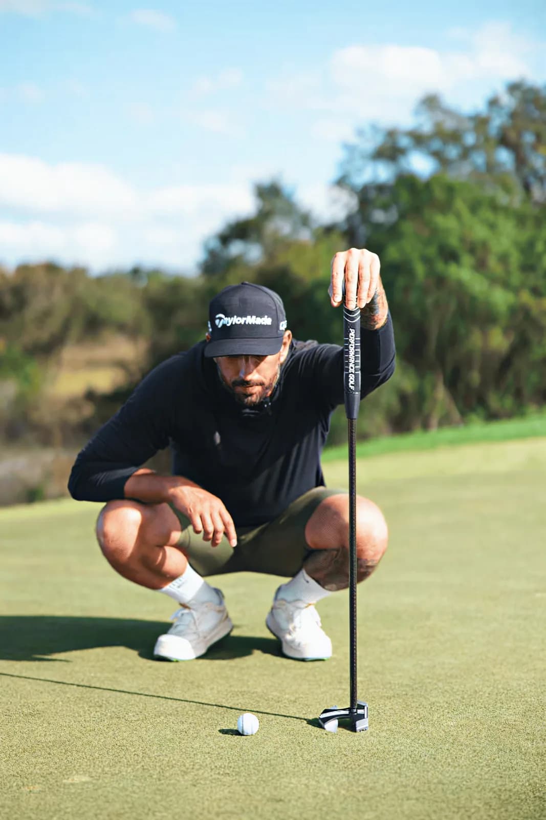 RS1 putter laid on green grass with headcover, overhead view