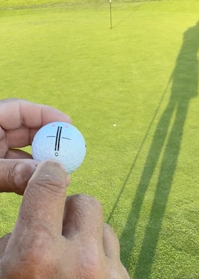 Golfer lining up the iON+ alignment artwork on the green