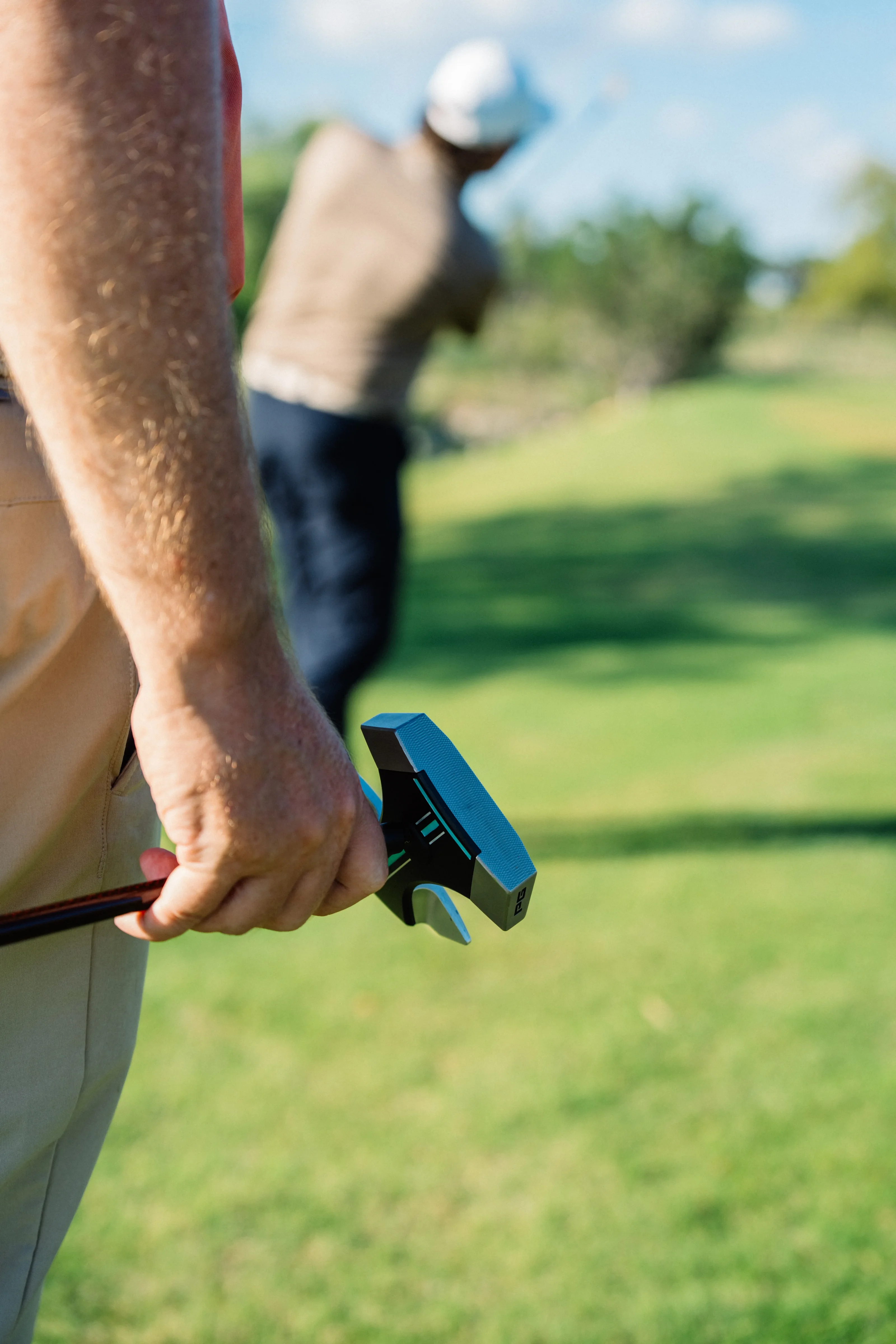 Golfer walking with RS1 putter in hand