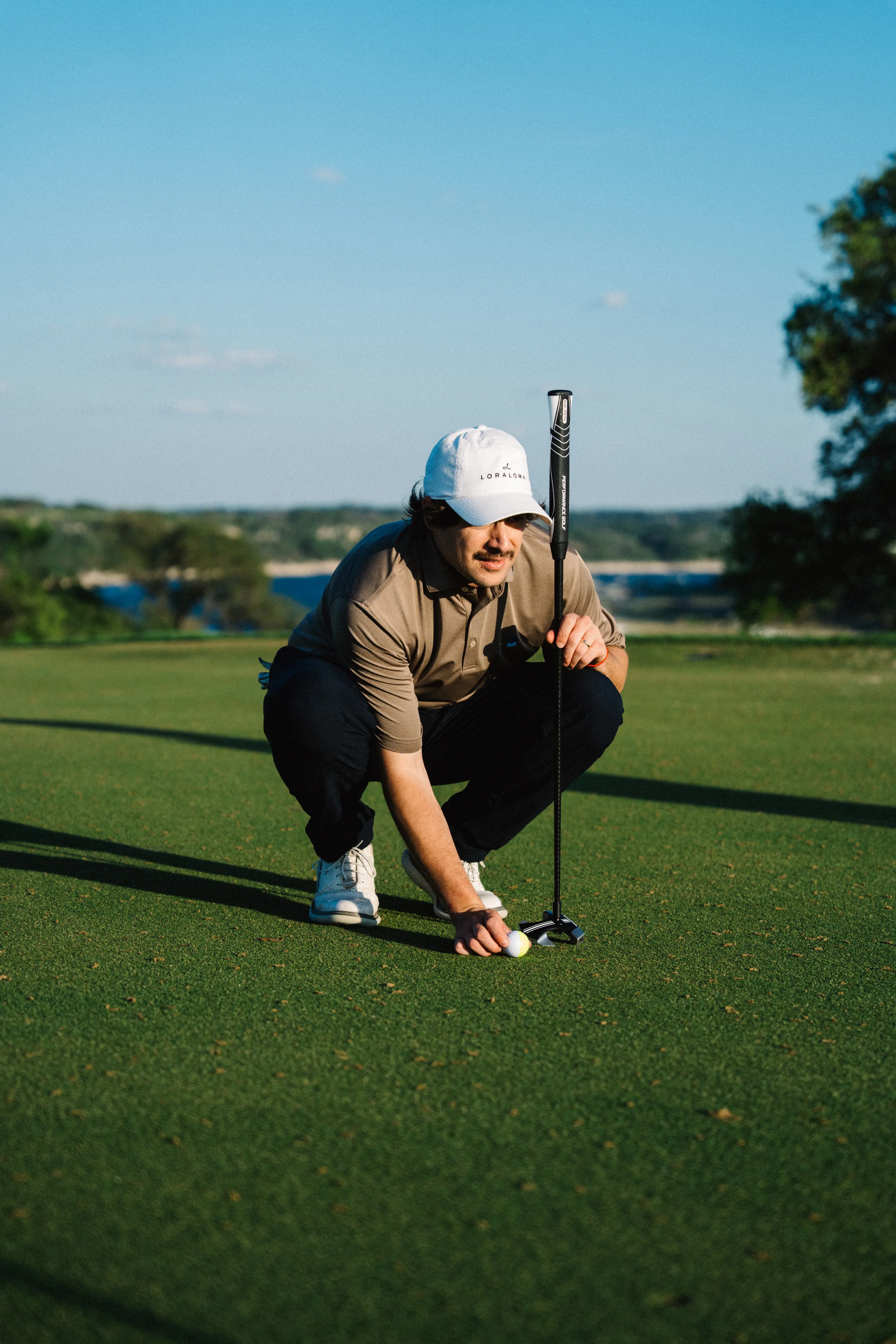 Golfer crouching to read the line with RS1