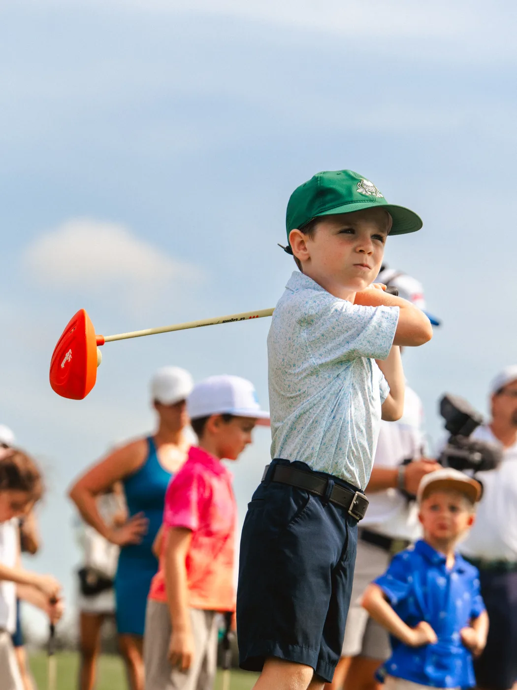 Young golfer holding his finish after a swing